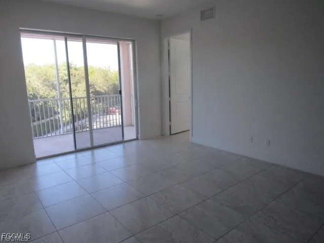 a view of an empty room with glass door