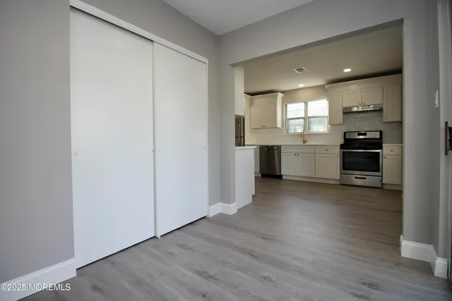 a kitchen with stainless steel appliances a refrigerator and a stove top oven