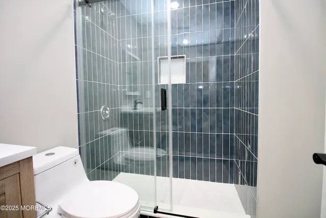 a bathroom with a toilet and shower
