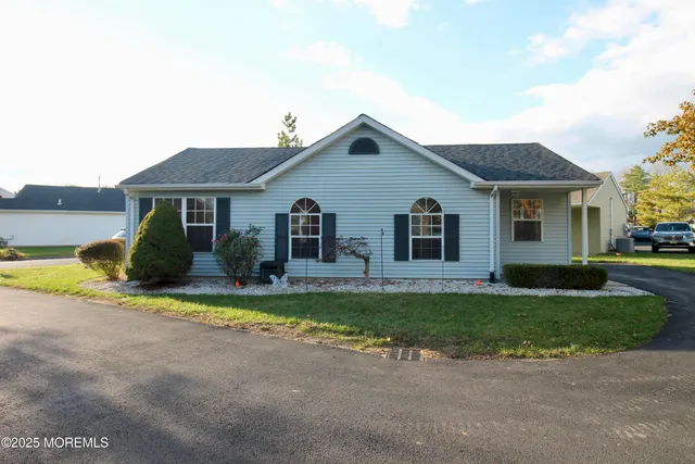 a view of a house with a yard and plants
