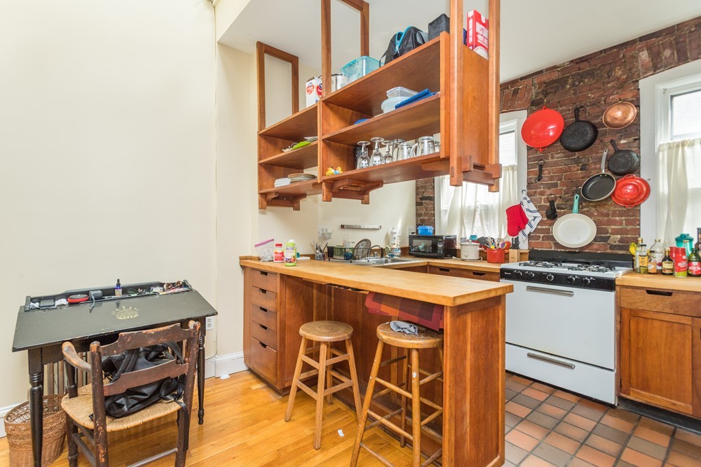 20 Grove Street Boston, MA 02114 - Photo 15 of 29 a kitchen with stainless steel appliances granite countertop a sink and a stove