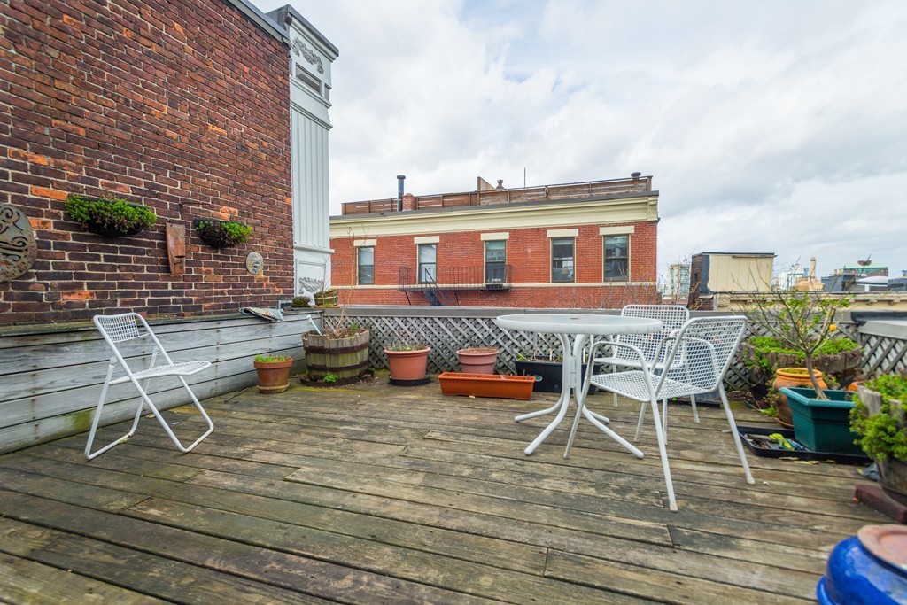 20 Grove Street Boston, MA 02114 - Photo 17 of 29 a view of a patio with table and chairs and potted plants