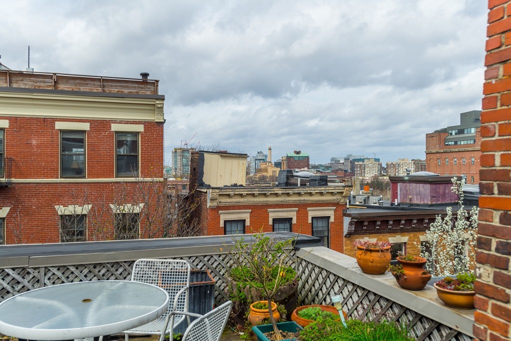20 Grove Street Boston, MA 02114 - Photo 18 of 29 a view of a roof deck with table and chairs