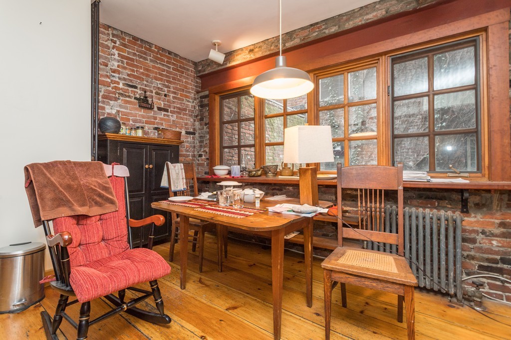 20 Grove Street Boston, MA 02114 - Photo 24 of 29 a dining room with furniture and a floor to ceiling window