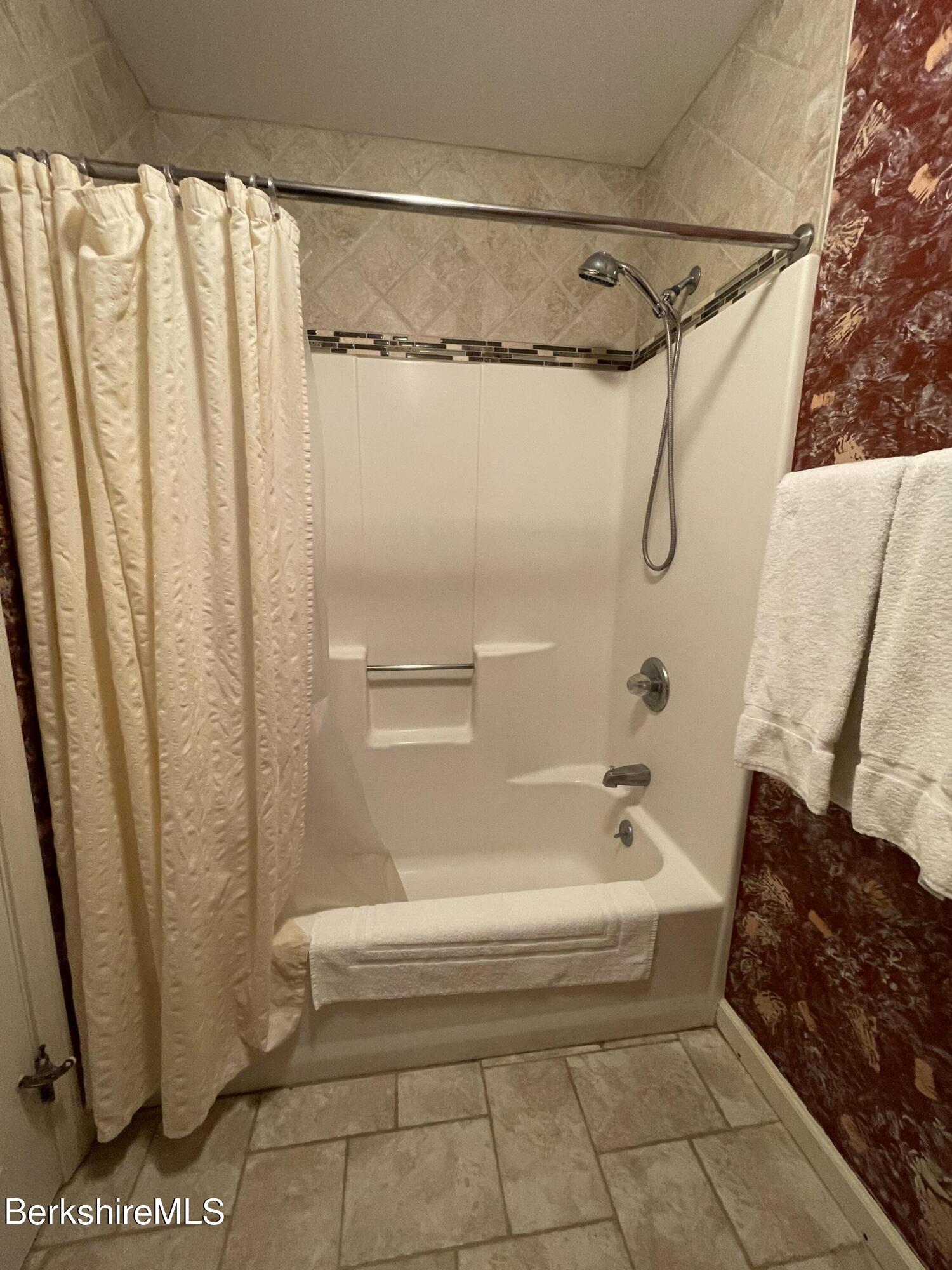 37 Corey Road, Unit 822 Hancock, MA 01237 - Photo 22 of 25 a bathroom with a shower and a bath tub