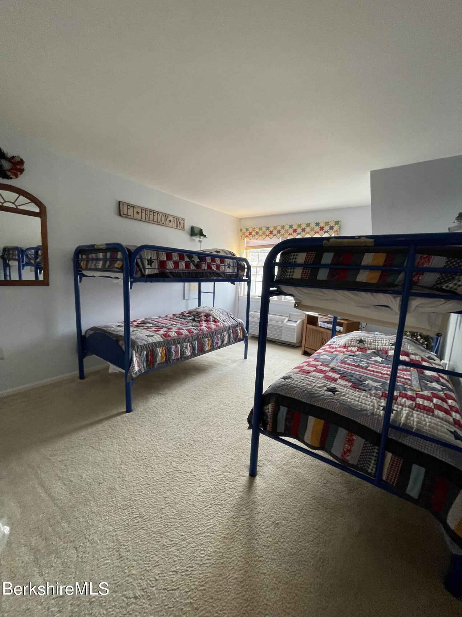 37 Corey Road, Unit 822 Hancock, MA 01237 - Photo 24 of 25 a bedroom with furniture and a window
