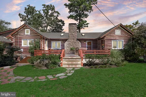 a front view of a house with a garden and plants
