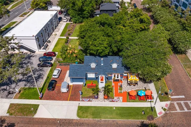 an aerial view of residential houses with outdoor space and swimming pool
