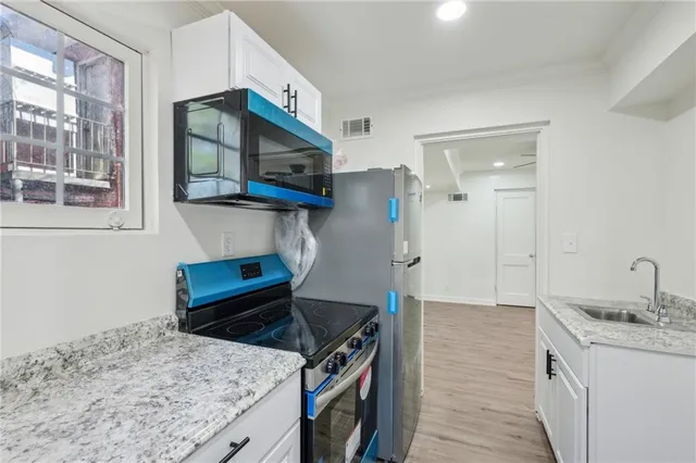 a kitchen with a sink stove and microwave