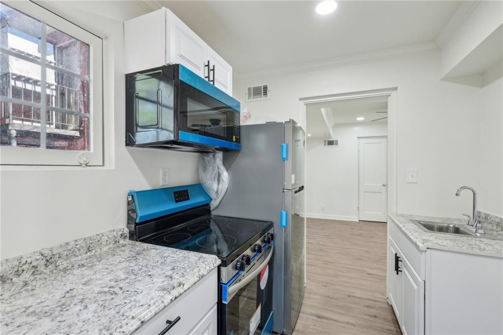 1004 Wylie Street Southeast, Unit 4 Atlanta, GA 30307 - Photo 11 of 19 a kitchen with a sink stove and microwave