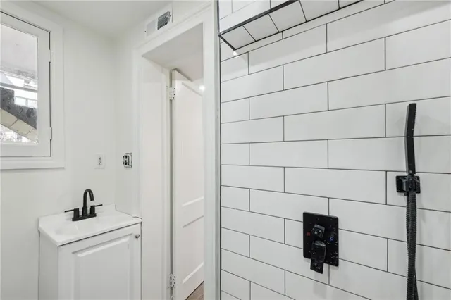 a bathroom with a shower and vanity