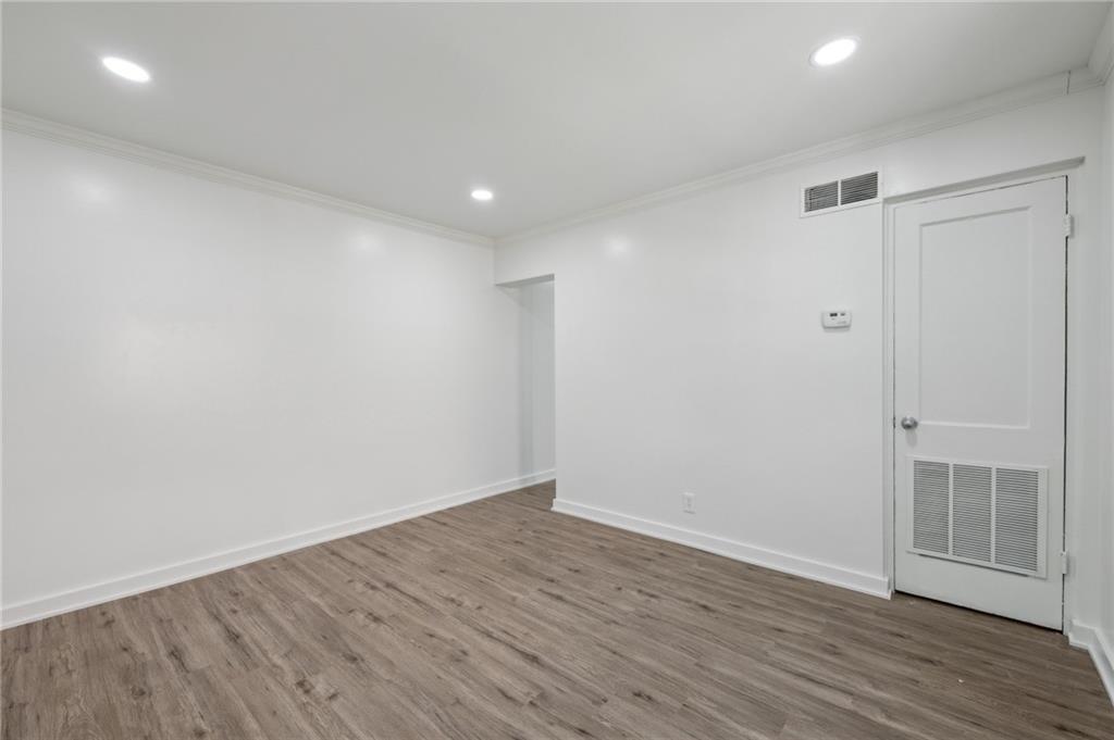 1004 Wylie Street Southeast, Unit 4 Atlanta, GA 30307 - Photo 5 of 19 a view of an empty room with wooden floor