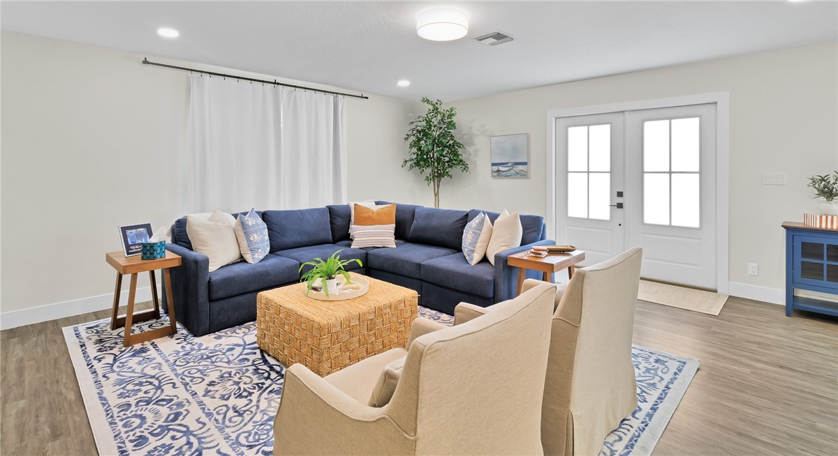 7989 143rd Street Sebastian, FL 32958 - Photo 3 of 30 a living room with furniture and wooden floor