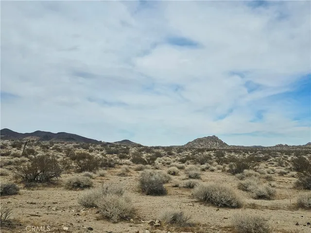 a view of a large mountain with mountains in the background