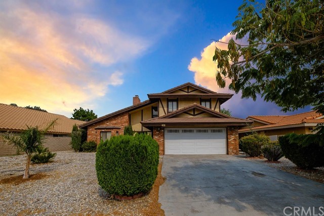 12915 Rain Shadow Road Victorville, CA 92395 - Photo 1 of 1 a front view of a house with a garden