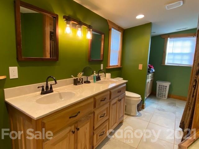 5281 Jenkins Road Morganton, NC 28655 - Photo 12 of 31 a bathroom with a sink mirror and a toilet
