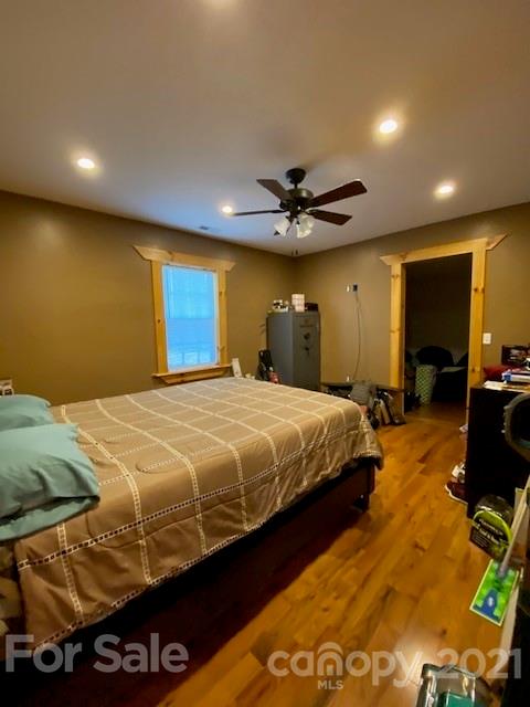 5281 Jenkins Road Morganton, NC 28655 - Photo 17 of 31 a bedroom with a bed and a chandelier
