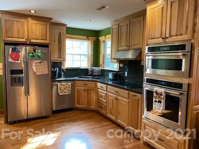 5281 Jenkins Road Morganton, NC 28655 - Photo 5 of 31 a kitchen with granite countertop a stove a sink and a refrigerator