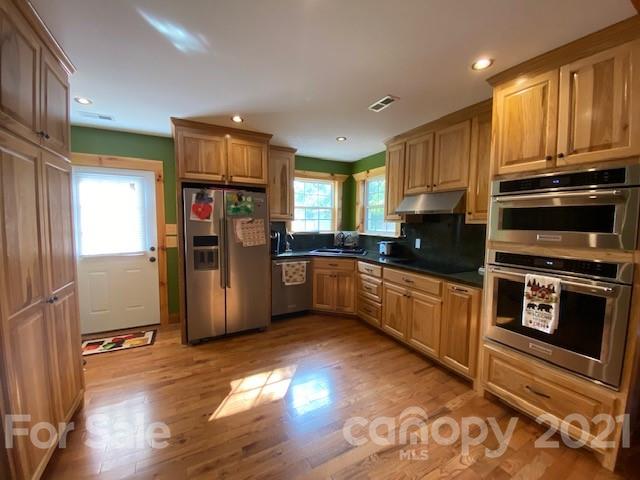5281 Jenkins Road Morganton, NC 28655 - Photo 6 of 31 a kitchen with stainless steel appliances wooden cabinets a stove and a refrigerator