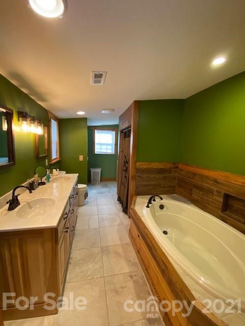 5281 Jenkins Road Morganton, NC 28655 - Photo 10 of 31 a bathroom with a tub sink and mirror