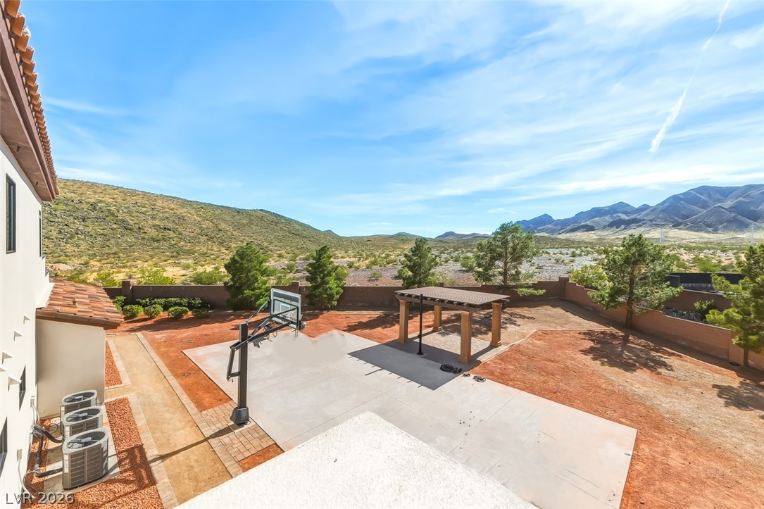 1140 Julie Road Henderson, NV 89002 - Photo 63 of 71 1140 JULIE RD HENDERSON NV 89002 SPORT COURT! Pickleball, basketball, badminton and more! Backyard court for active living, framed by desert mountains and clear skies.