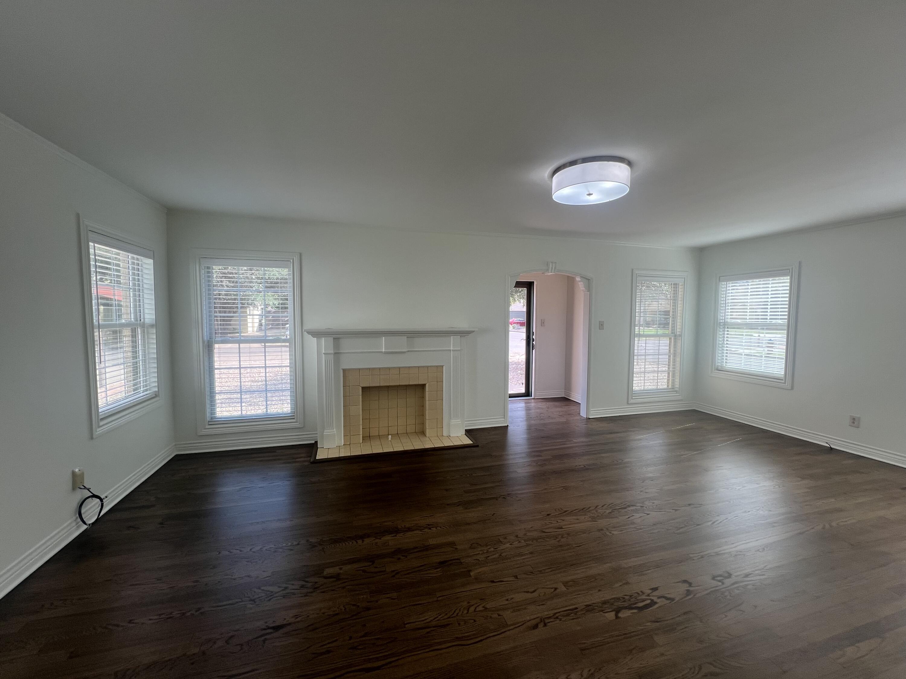 2916 21st Street Lubbock, TX 79410 - Photo 14 of 28 an empty room with wooden floor and windows