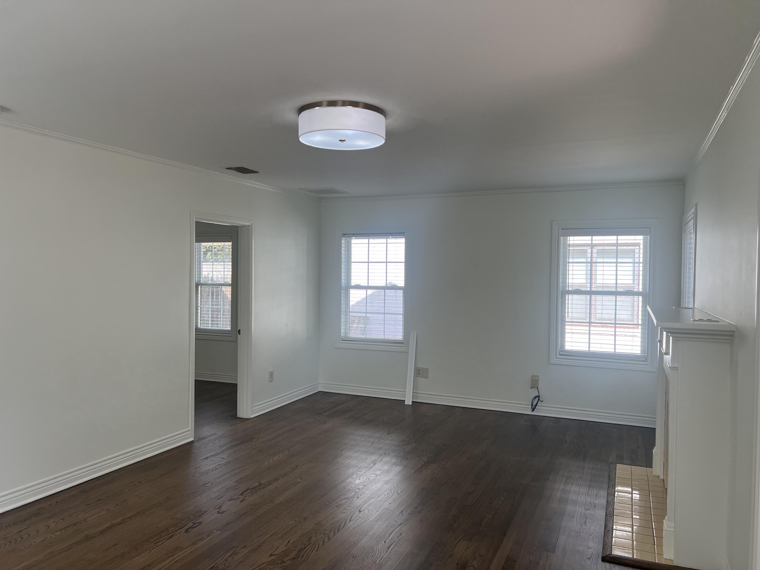 2916 21st Street Lubbock, TX 79410 - Photo 16 of 28 an empty room with wooden floor and windows