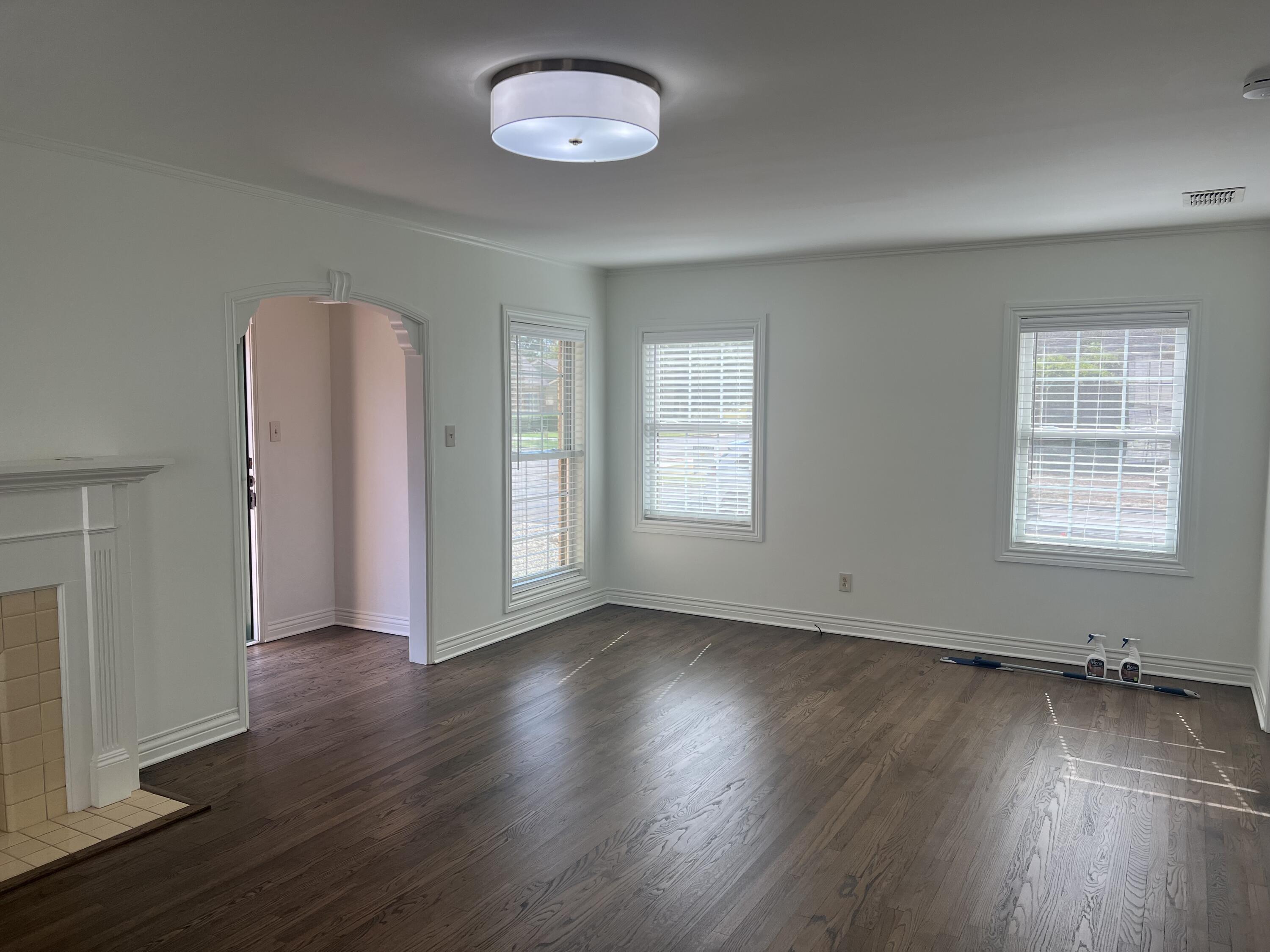 2916 21st Street Lubbock, TX 79410 - Photo 17 of 28 an empty room with wooden floor and windows