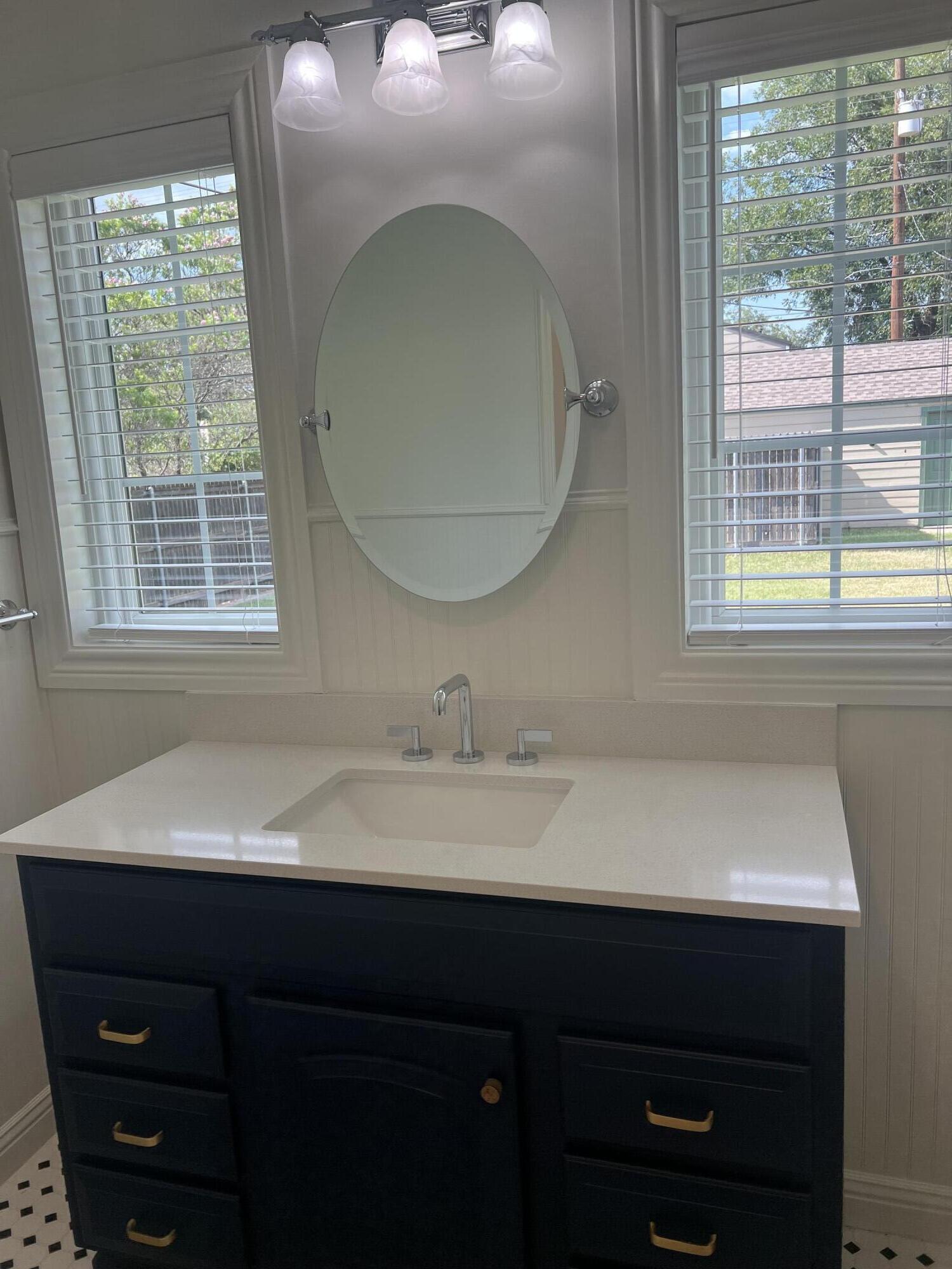 2916 21st Street Lubbock, TX 79410 - Photo 18 of 28 a bathroom with a sink and a mirror