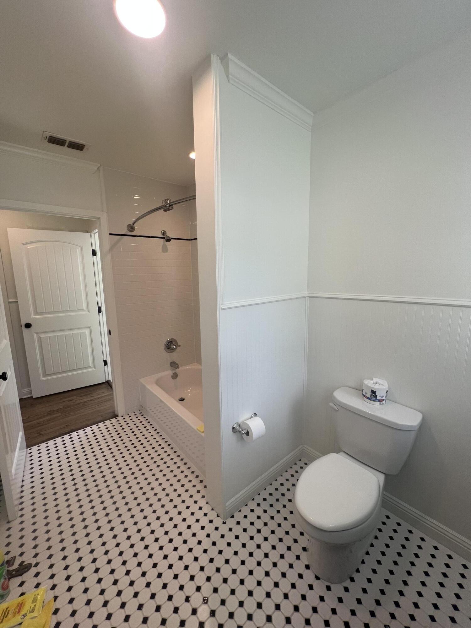2916 21st Street Lubbock, TX 79410 - Photo 20 of 28 a bathroom with a toilet and a shower