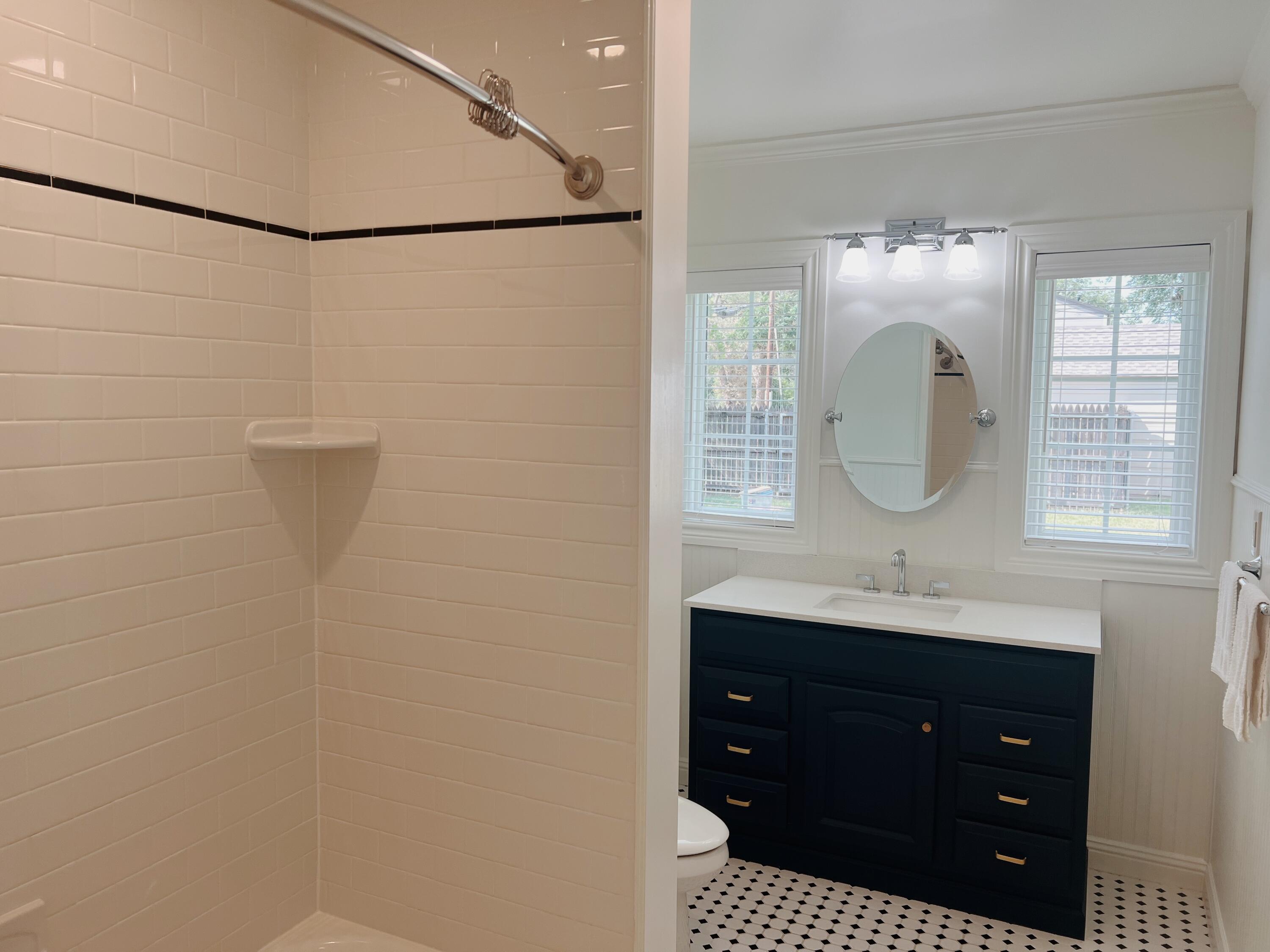2916 21st Street Lubbock, TX 79410 - Photo 21 of 28 a bathroom with a sink vanity and mirror