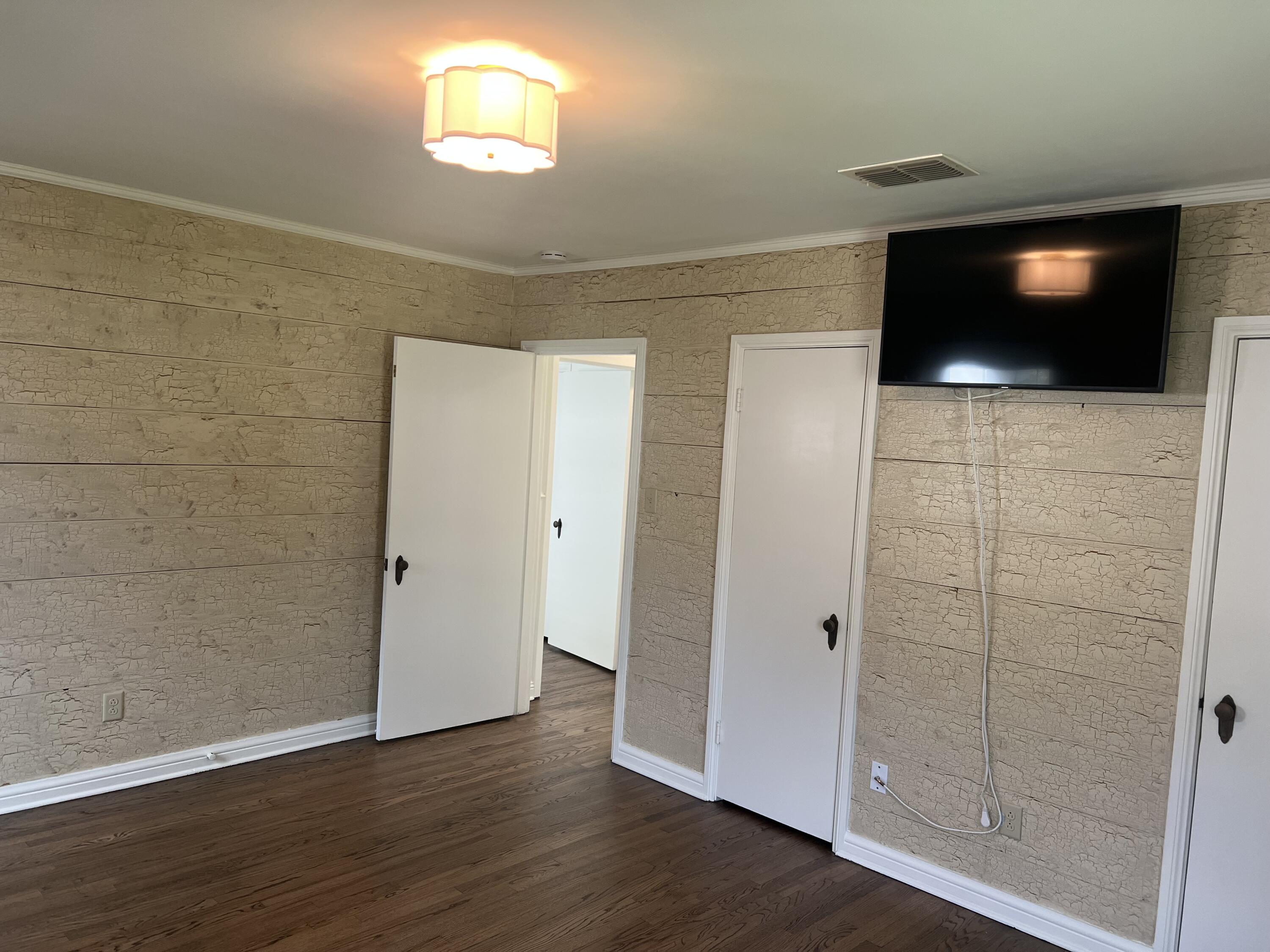 2916 21st Street Lubbock, TX 79410 - Photo 23 of 28 a view of a livingroom with wooden floor and windows