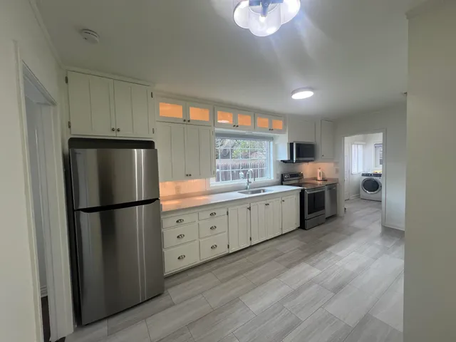 a kitchen with a refrigerator and a sink