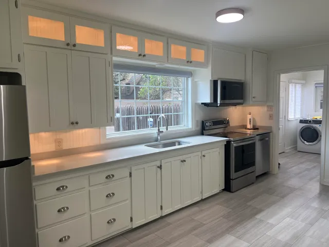 a kitchen with cabinets a sink and a stove