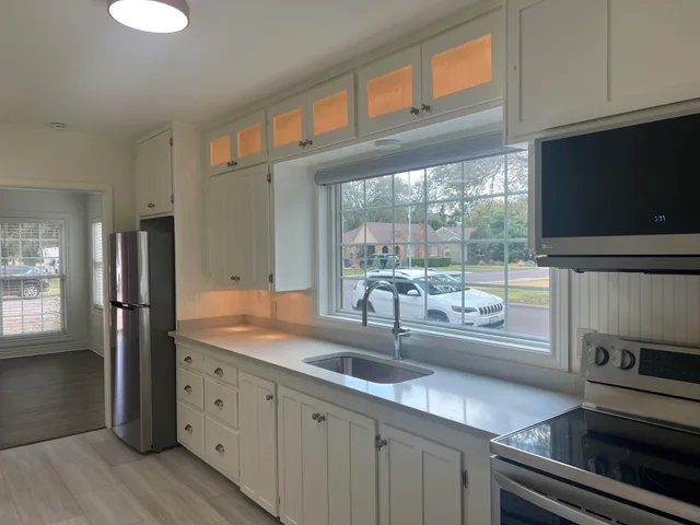 a kitchen with granite countertop a oven stove top oven and sink