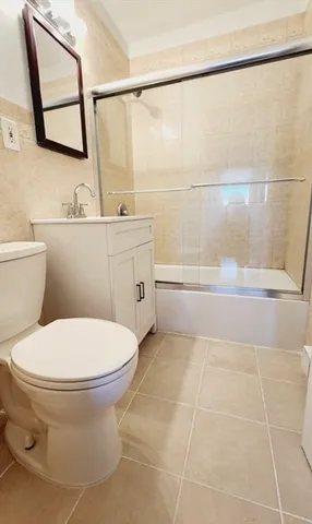 a bathroom with a toilet a sink and a mirror