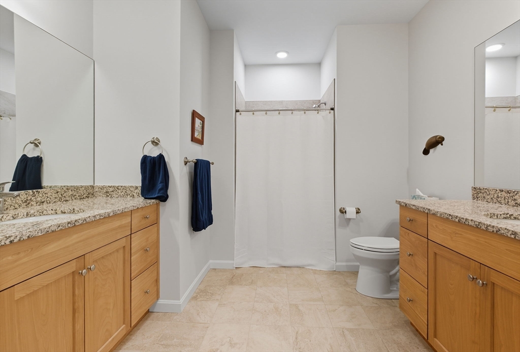 60 Coppersmith Way, Unit 208 Canton, MA 02021 - Photo 11 of 23 a bathroom with a granite countertop sink a toilet and shower