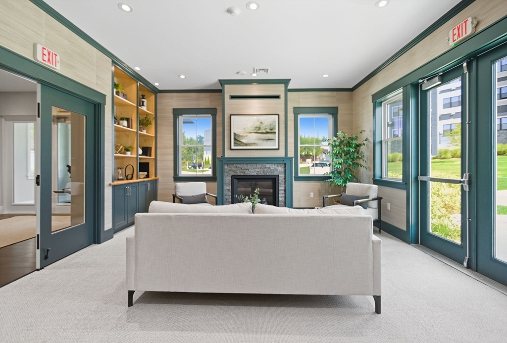 60 Coppersmith Way, Unit 208 Canton, MA 02021 - Photo 17 of 23 a living room with fireplace furniture and a large window