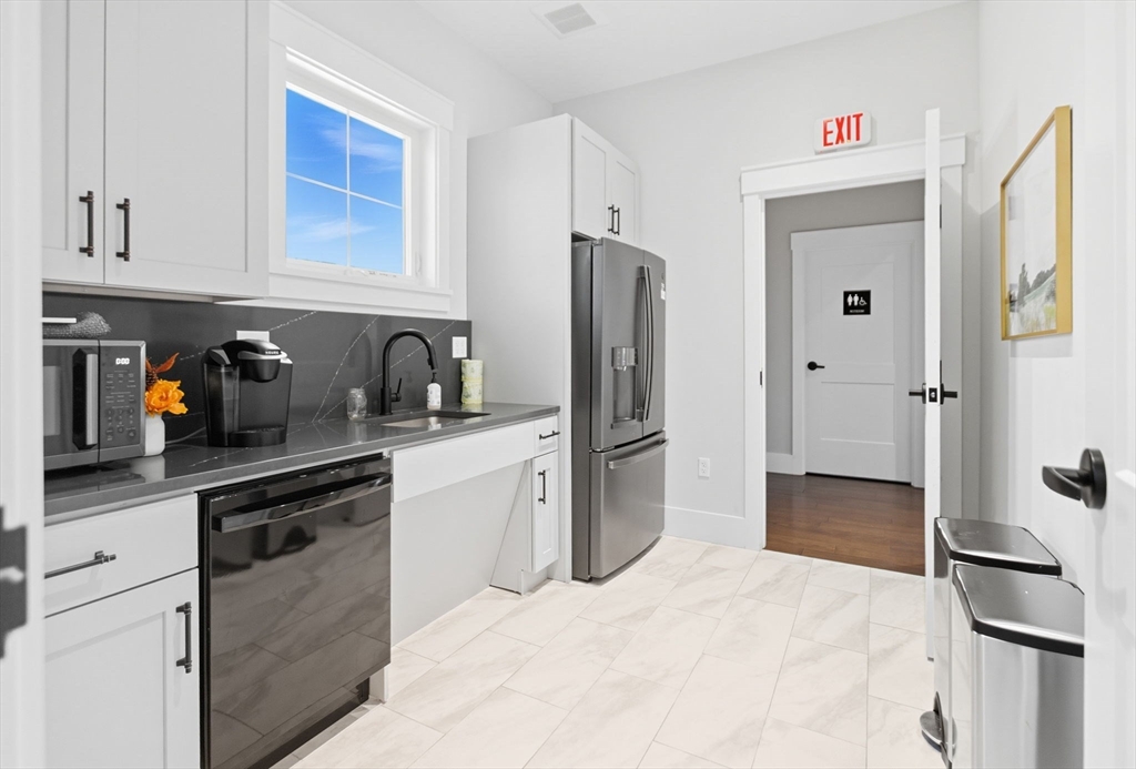 60 Coppersmith Way, Unit 208 Canton, MA 02021 - Photo 20 of 23 a kitchen with stainless steel appliances a refrigerator sink and cabinets