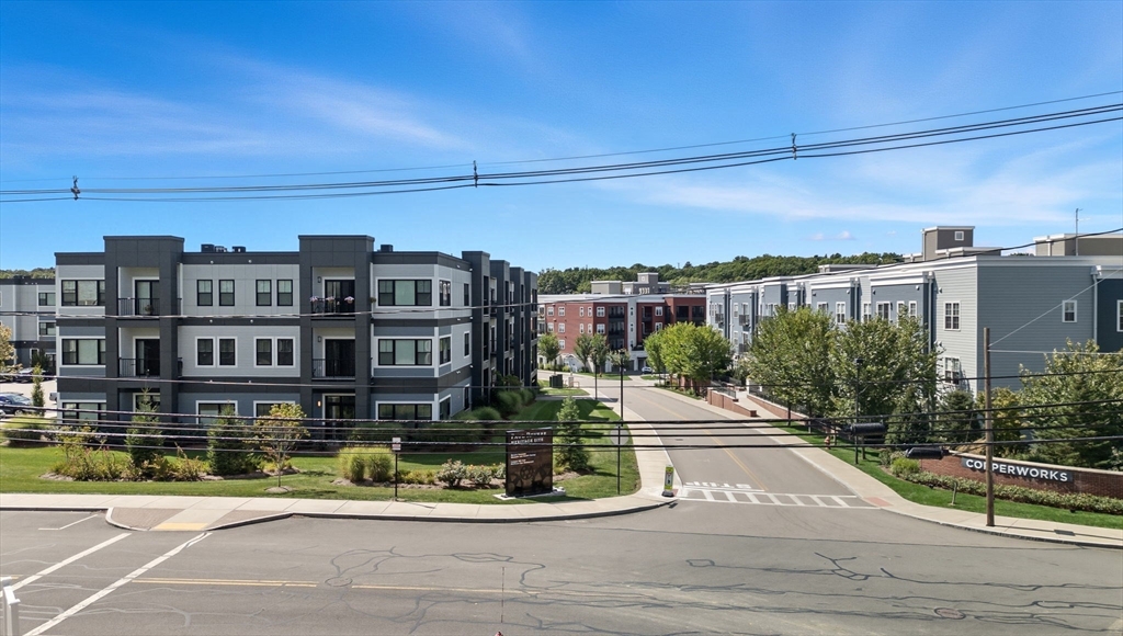 60 Coppersmith Way, Unit 208 Canton, MA 02021 - Photo 3 of 23 a view of a swimming pool with a patio
