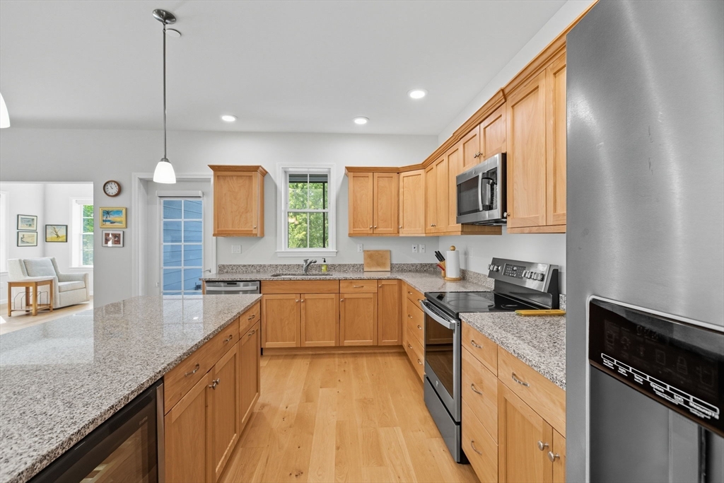 60 Coppersmith Way, Unit 208 Canton, MA 02021 - Photo 4 of 23 a kitchen with stainless steel appliances granite countertop sink stove top oven and cabinets