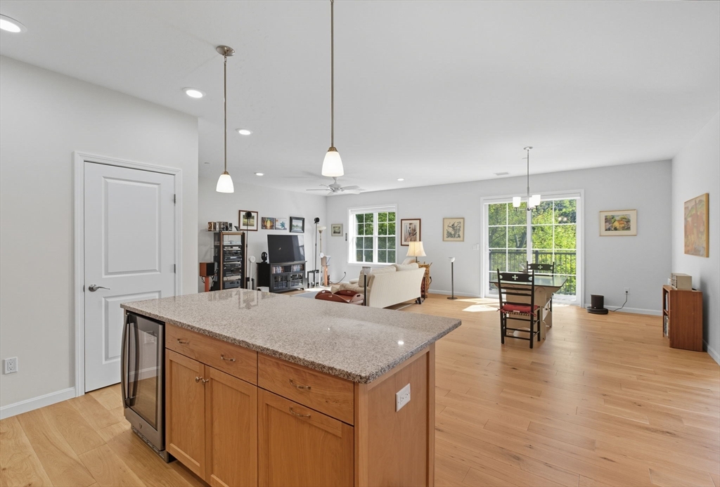 60 Coppersmith Way, Unit 208 Canton, MA 02021 - Photo 5 of 23 a view of living room with granite countertop furniture and fireplace