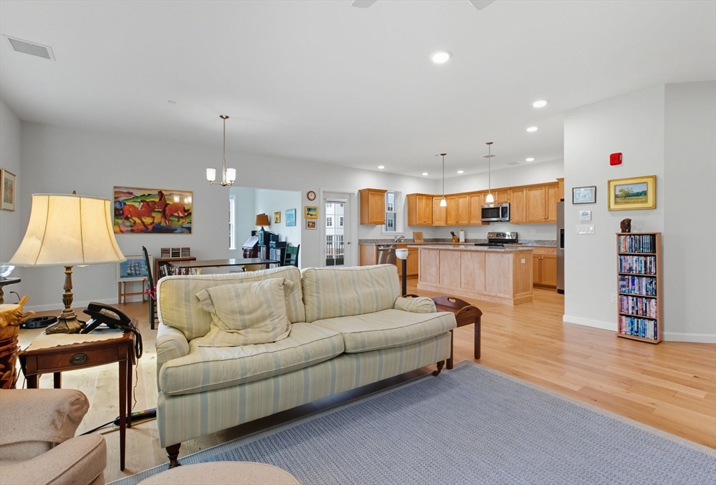 60 Coppersmith Way, Unit 208 Canton, MA 02021 - Photo 7 of 23 a living room with furniture and a flat screen tv