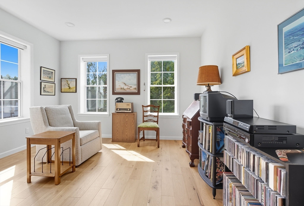 60 Coppersmith Way, Unit 208 Canton, MA 02021 - Photo 8 of 23 a living room with furniture and a flat screen tv