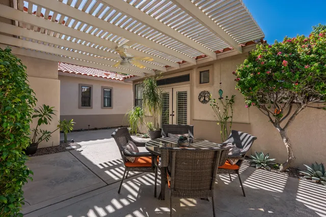 a view of a patio with table and chairs and potted plants