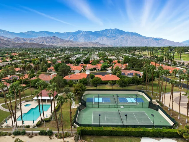 a view of a lake with a table and chairs