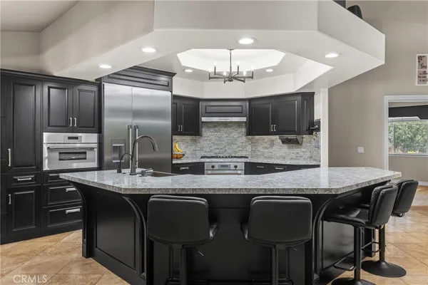 a view of a kitchen area with granite countertop stainless steel appliances stove and microwave