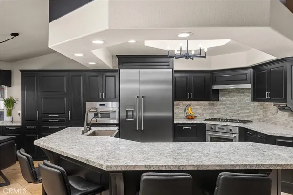 a kitchen with a table chairs stove and refrigerator