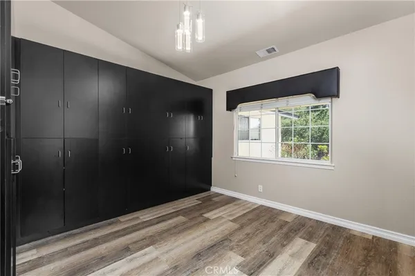 a bathroom with a granite countertop sink toilet a mirror and bathtub