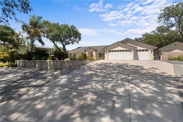 a view of a swimming pool with a patio and plants
